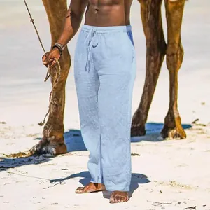 Detail view of men's loose light blue cotton linen breathable casual beach pants on model