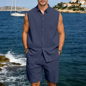 Men's navy blue linen sleeveless beach shirt and shorts set shown on a sunny coast
