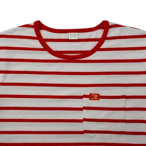 Close-up detail of a red and white horizontal striped t-shirt with a chest pocket and label