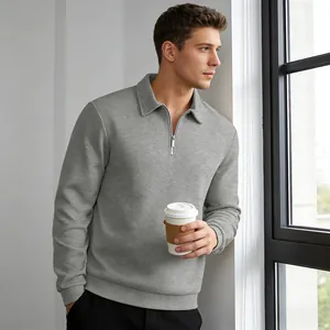 Close-up of men's grey textured jacquard quarter-zip sweatshirt showing fabric detail.