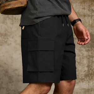 Detail of men's black outdoor cargo shorts with large flap pocket and drawstring waist