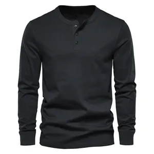 Close-up front view of a black men's long sleeve Henley shirt with buttoned collar
