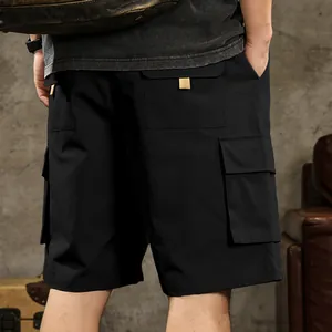 Close-up detail of black men's cargo shorts with multi-pocket design for outdoor use.
