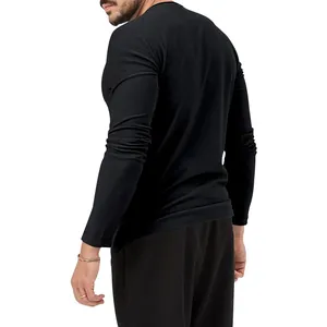 Back view of a slim fit men's long sleeve black t-shirt with a classic round neckline