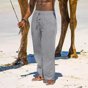 Men's breathable grey cotton linen wide leg trousers shown in a beach setting