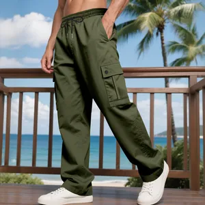 Men's olive green quick-dry cargo pants with drawstring waist in outdoor beach setting