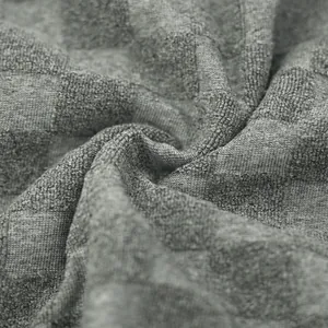 Close-up of gray heavyweight checkerboard jacquard knit fabric showing soft texture detail.