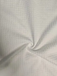 Macro detail showing the breathable waffle texture of the white heavy-weight men's T-shirt.