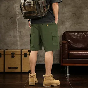 Back view of men's green cargo shorts with multi-pockets in a vintage room
