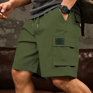 Side view detail of men's olive green cargo shorts with multi-pockets and drawstring