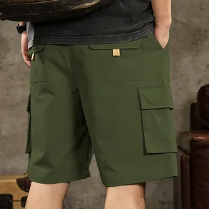 Detailed macro view of the back pockets on olive green outdoor men's cargo shorts