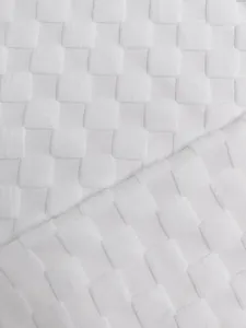 Macro detail of white heavyweight jacquard fabric with 3D checkerboard pattern