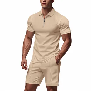 Full body view of a male model wearing a beige waffle knit zipper polo shirt and matching shorts