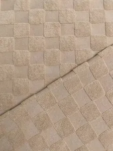 Detailed macro view of heavyweight jacquard knit fabric with a textured checkerboard pattern