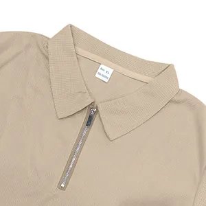 Close-up of men's beige waffle knit polo shirt with quarter-zip collar detail