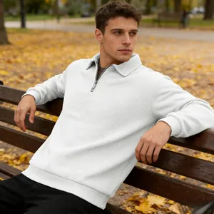 Detailed view of men's white quarter-zip sweatshirt with textured jacquard pattern