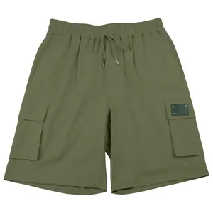 Detail showing olive green cargo shorts with multiple pockets and drawstring waist