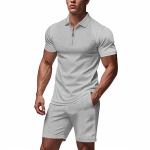 Close-up of a grey waffle knit polo shirt and matching shorts set worn by an athletic male model
