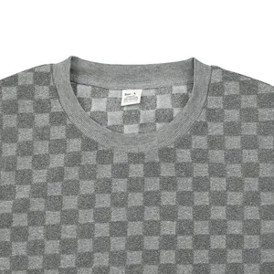 Detail shot of men's grey checkered knit sweater collar and heavy jacquard fabric texture