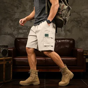 Men's khaki cargo shorts featuring multiple pockets in a rugged outdoor lifestyle setting