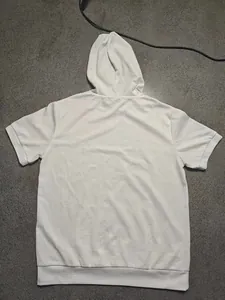 Rear view of a white hooded short sleeve t-shirt with textured waffle fabric pattern