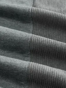Dettaglio macro della felpa grigia da uomo con trama in velluto a coste patchwork
