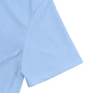 Close-up detail of light blue waffle knit shirt sleeve showing fine double stitching
