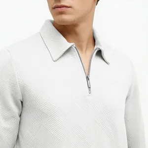 Close-up of men's polo shirt with textured jacquard fabric and silver zipper neck detail