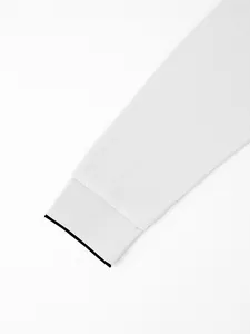 Close-up detail of a white men's quick-dry long sleeve Polo shirt cuff with black trim