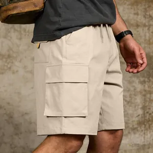Detail of men's beige cargo shorts featuring a large utility flap pocket and drawstring waist.