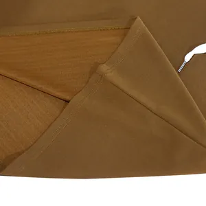 Close-up of brown hooded vest fabric detail with precision stitching and a white drawstring