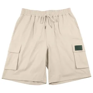 Front view of beige cargo shorts with elastic drawstring waist and side pockets.