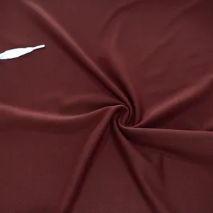 Detailed macro view of maroon breathable mesh fabric texture on a men's sport vest