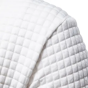 Close-up detail of white quilted jacquard fabric texture on a men's sweatshirt