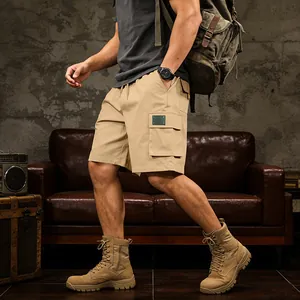 Outdoor men's khaki cargo shorts with multiple pockets shown with tactical boots