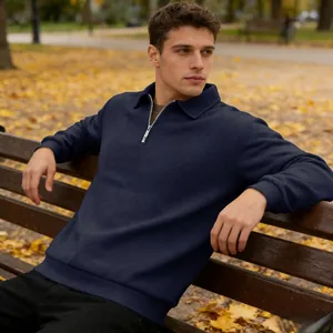 Detailed view of navy blue textured jacquard long sleeve quarter-zip polo sweatshirt