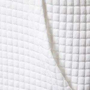 Detailed macro shot of premium white quilted jacquard fabric for men's casual sweatshirt suits