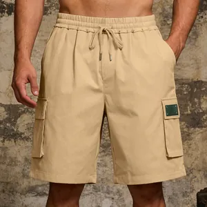 Detail view of khaki men's cargo shorts with multi-pockets and drawstring waist