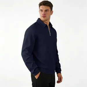 Detail of navy blue men's quarter-zip polo sweatshirt featuring textured geometric pattern
