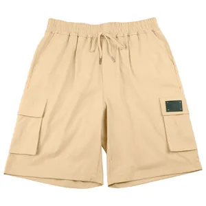 Close-up of men's khaki cargo shorts featuring multi-pocket design and drawstring waist.