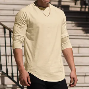 Close-up of a men's cream long-sleeve T-shirt featuring a curved hem design
