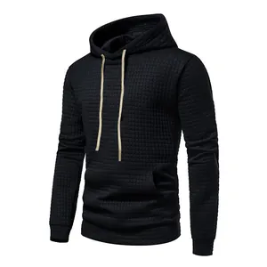 Close-up of black men's long sleeve jacquard hoodie with waffle texture and drawstrings