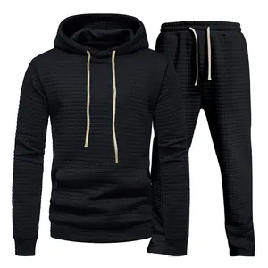 Detail view of black men's textured jacquard hoodie and matching sweatpants tracksuit set