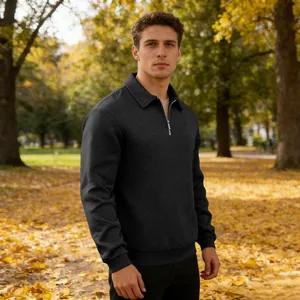 Detail of men's black long sleeve polo sweatshirt with textured jacquard pattern and zip neck.