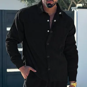Detailed close-up of men's black corduroy shirt showing fabric texture and buttons