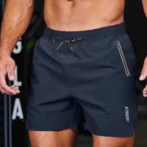 Close-up detail of navy blue men's athletic gym shorts with drawstring and zipper