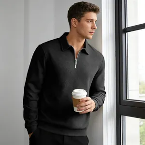 Detailed view of a man wearing a black textured jacquard long-sleeve polo sweatshirt