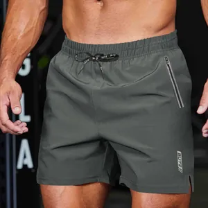 Close-up of men's dark grey athletic shorts showing drawstring and zipper pocket details