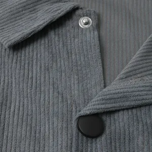 Detailed macro shot of grey corduroy men's shirt showing fabric texture and buttons
