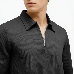 Macro view of men's black jacquard polo sweatshirt showing quarter-zip and texture detail